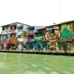 Colourful murals on buildings lining the Malacca River
