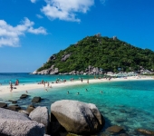 Tourists walking between islands at low tide