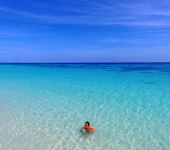 Girl swimming in clear water at Koh Rok group